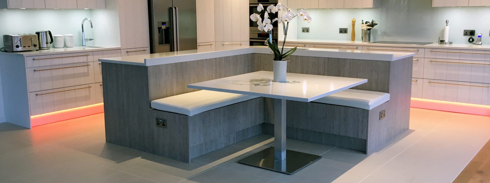 Grey open plan kitchen with island and seating area