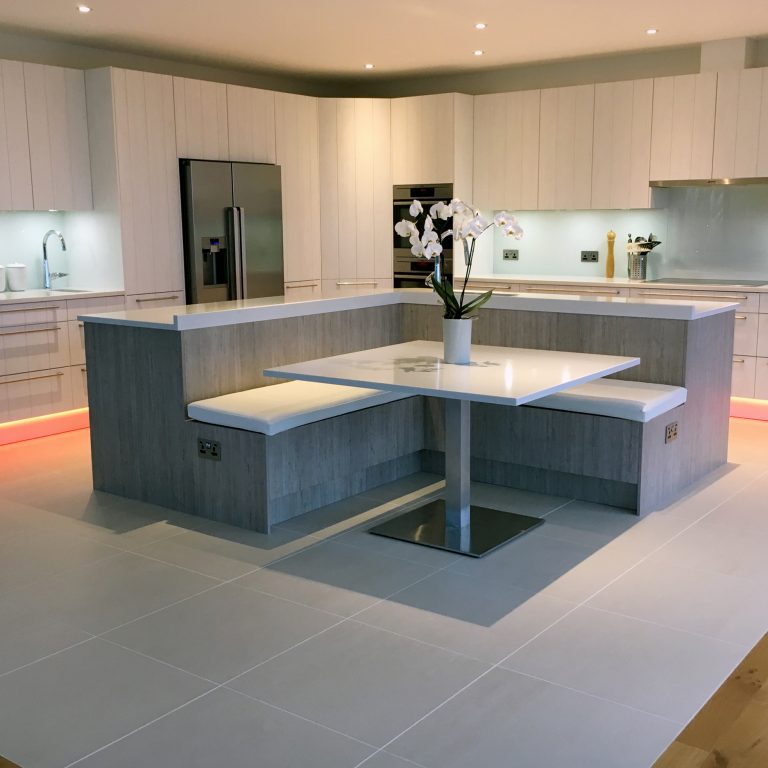 Grey open plan kitchen with island and seating area